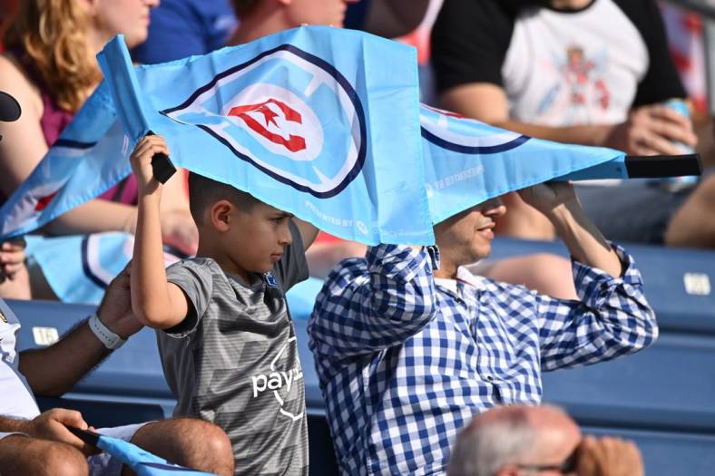 Aug 21, 2022; Chicago, Illinois, USA;  Fans shield themselves from the sun using their Chicago Fire FC flags during the first half of a game against New York City FC at Bridgeview Stadium. Mandatory Credit: Jamie Sabau-USA TODAY Sports
