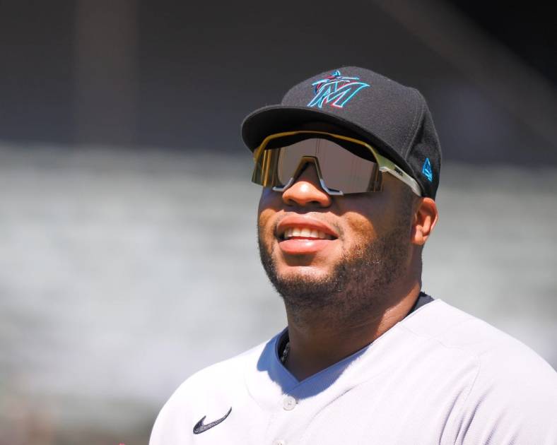 Aug 24, 2022; Oakland, California, USA; Miami Marlins first baseman Jesus Aguilar (99) returns to the dugout after the second inning at RingCentral Coliseum. Mandatory Credit: Kelley L Cox-USA TODAY Sports