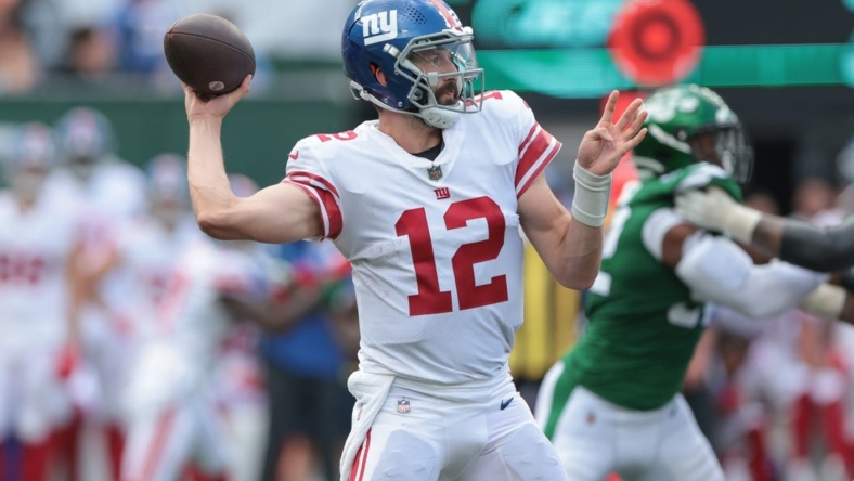 Aug 28, 2022; East Rutherford, New Jersey, USA; New York Giants quarterback Davis Webb (12) throws the ball against the New York Jets during the second half at MetLife Stadium. Mandatory Credit: Vincent Carchietta-USA TODAY Sports
