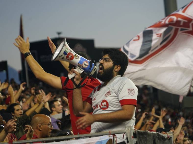 Aug 31, 2022; Toronto, Ontario, CAN; A member of a Toronto FC supporters group leads the fans in a cheer during a game against LA Galaxy at BMO Field. Mandatory Credit: John E. Sokolowski-USA TODAY Sports