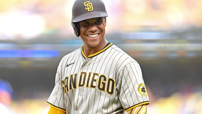 Sep 4, 2022; Los Angeles, California, USA;  San Diego Padres right fielder Juan Soto (22) smiles as he talks with players in the Los Angeles Dodgers dugout in the third inning at Dodger Stadium. Mandatory Credit: Jayne Kamin-Oncea-USA TODAY Sports