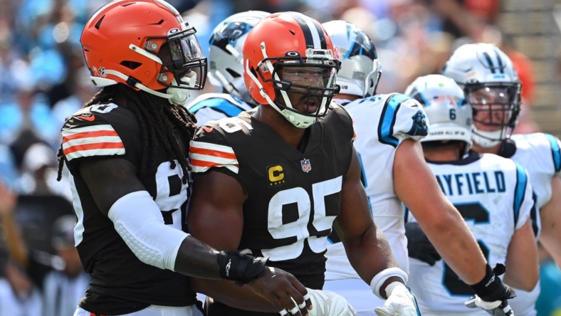 Sep 11, 2022; Charlotte, North Carolina, USA; Cleveland Browns defensive end Myles Garrett (95) reacts with defensive end Jadeveon Clowney (90) after sacking Carolina Panthers quarterback Baker Mayfield (6) in the third quarter at Bank of America Stadium. Mandatory Credit: Bob Donnan-USA TODAY Sports
