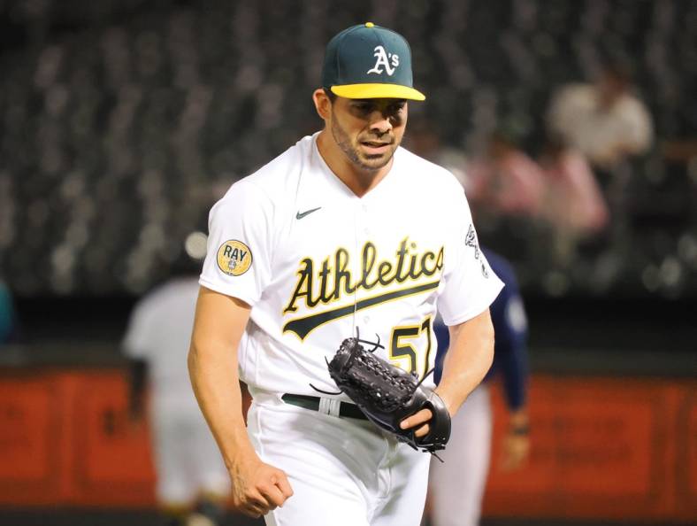 Sep 20, 2022; Oakland, California, USA; Oakland Athletics pitcher Tyler Cyr (57) celebrates after the top of the eighth inning against the Seattle Mariners at RingCentral Coliseum. Mandatory Credit: Kelley L Cox-USA TODAY Sports