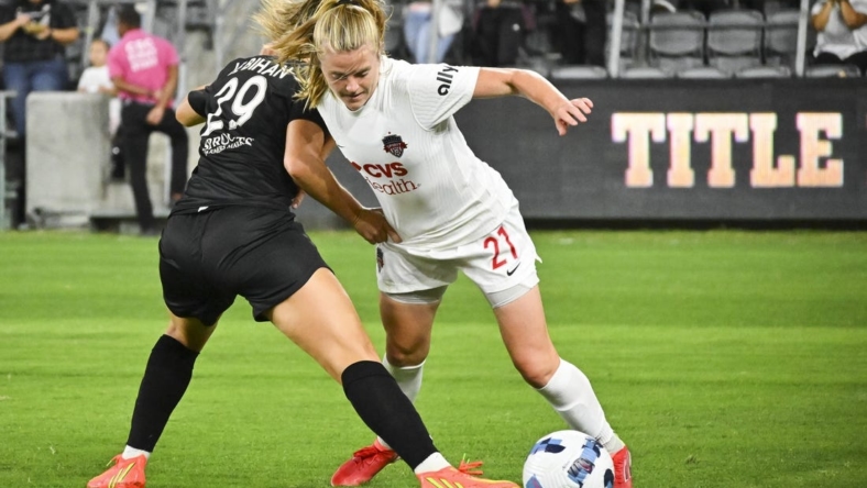 Sep 21, 2022; Los Angeles, California, USA; Washington Spirit midfielder Anna Heilferty (21) and Angel City FC midfielder Clarisse Le Bihan (29) battle for possession during the first half of a NWSL match at Banc of California Stadium. Mandatory Credit: Jayne Kamin-Oncea-USA TODAY Sports