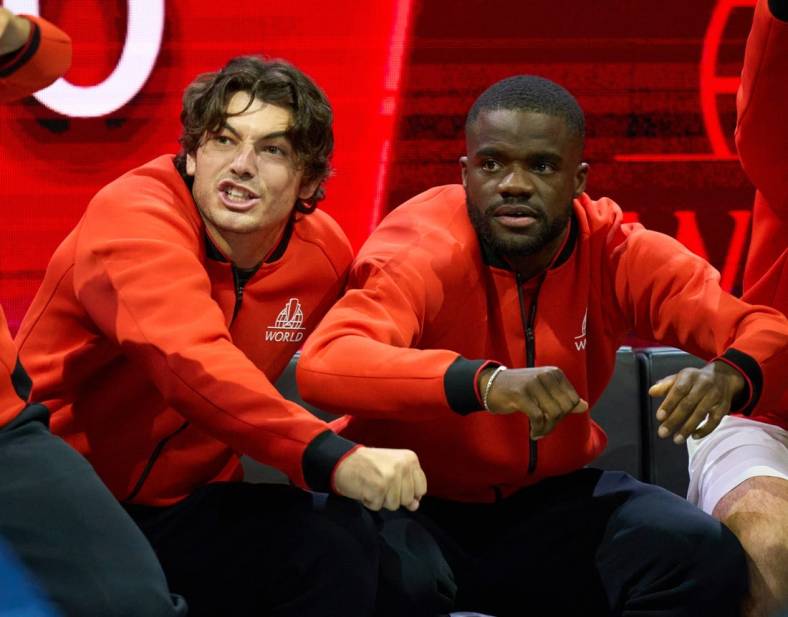 Sep 23, 2022; London, United Kingdom;  Team World players, Taylor Fritz (USA) and Frances Tiafoe (USA),  show their support in the Laver Cup tennis match between Andy Murray (GBR) and Alex De Minaur (AUS) as Team World captain John McEnroe looks on.  Mandatory Credit: Peter van den Berg-USA TODAY Sports