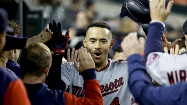 Sep 30, 2022; Detroit, Michigan, USA;  Minnesota Twins shortstop Carlos Correa (4) receives congratulations from teammates after he hits a two run home run in the seventh inning against the Detroit Tigers at Comerica Park. Mandatory Credit: Rick Osentoski-USA TODAY Sports