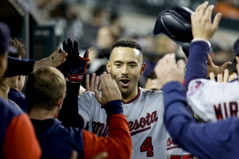 Sep 30, 2022; Detroit, Michigan, USA;  Minnesota Twins shortstop Carlos Correa (4) receives congratulations from teammates after he hits a two run home run in the seventh inning against the Detroit Tigers at Comerica Park. Mandatory Credit: Rick Osentoski-USA TODAY Sports
