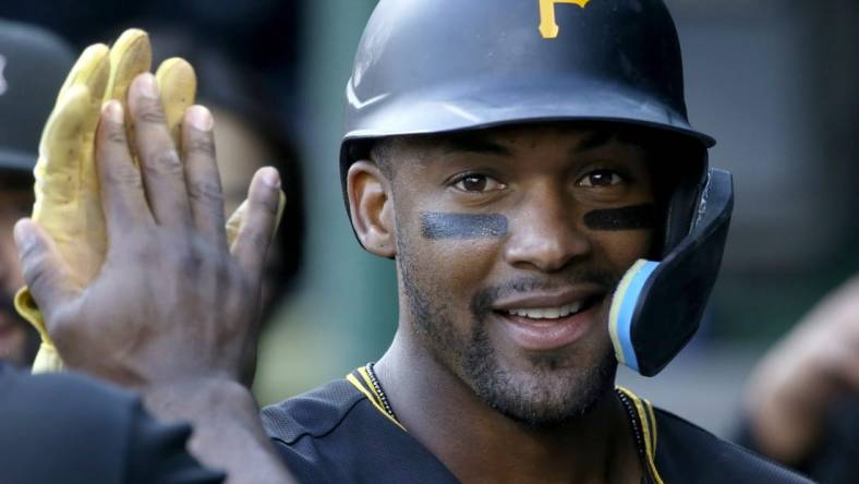 Oct 5, 2022; Pittsburgh, Pennsylvania, USA;  Pittsburgh Pirates left fielder Miguel Andujar (26) celebrates in the dugout after scoring against the St. Louis Cardinals during the fourth inning at PNC Park. Mandatory Credit: Charles LeClaire-USA TODAY Sports