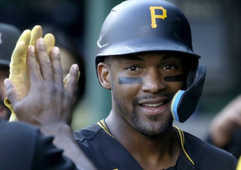 Oct 5, 2022; Pittsburgh, Pennsylvania, USA;  Pittsburgh Pirates left fielder Miguel Andujar (26) celebrates in the dugout after scoring against the St. Louis Cardinals during the fourth inning at PNC Park. Mandatory Credit: Charles LeClaire-USA TODAY Sports