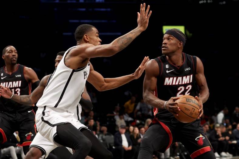 Oct 6, 2022; Brooklyn, New York, USA; Miami Heat forward Jimmy Butler (22) drives to the basket against Brooklyn Nets forward Nic Claxton (33) during the first quarter at Barclays Center. Mandatory Credit: Brad Penner-USA TODAY Sports