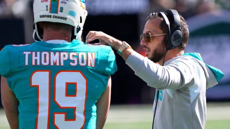 Oct 9, 2022; East Rutherford, New Jersey, USA; Miami Dolphins head coach Mike McDaniel talks with quarterback Skylar Thompson (19) between plays against the New York Jets during the first half at MetLife Stadium. Mandatory Credit: Robert Deutsch-USA TODAY Sports