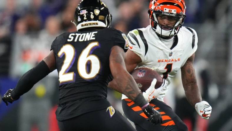 Cincinnati Bengals wide receiver Ja'Marr Chase (1) runs after a catch as Baltimore Ravens safety Geno Stone (26) defends in the fourth quarter during an NFL Week 5 game, Sunday, Oct. 9, 2022, at M&T Bank Stadium in Baltimore.

Nfl Cincinnati Bengals At Baltimore Ravens Oct 9 0318