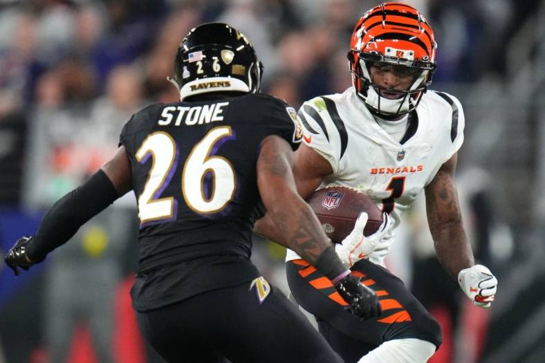 Cincinnati Bengals wide receiver Ja'Marr Chase (1) runs after a catch as Baltimore Ravens safety Geno Stone (26) defends in the fourth quarter during an NFL Week 5 game, Sunday, Oct. 9, 2022, at M&T Bank Stadium in Baltimore.

Nfl Cincinnati Bengals At Baltimore Ravens Oct 9 0318