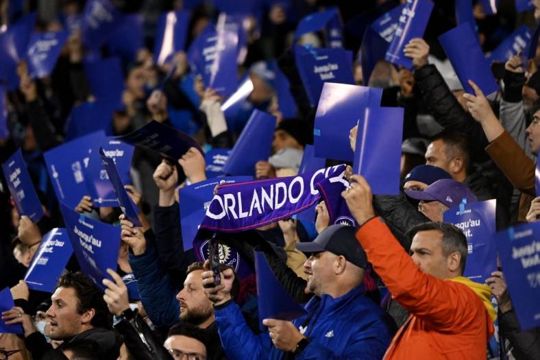 Oct 16, 2022; Montreal, Quebec, Canada; Orlando City fans cheer from the stands during the first half of the match between Orlando City and CF Montreal at Stade Saputo. Mandatory Credit: David Kirouac-USA TODAY Sports