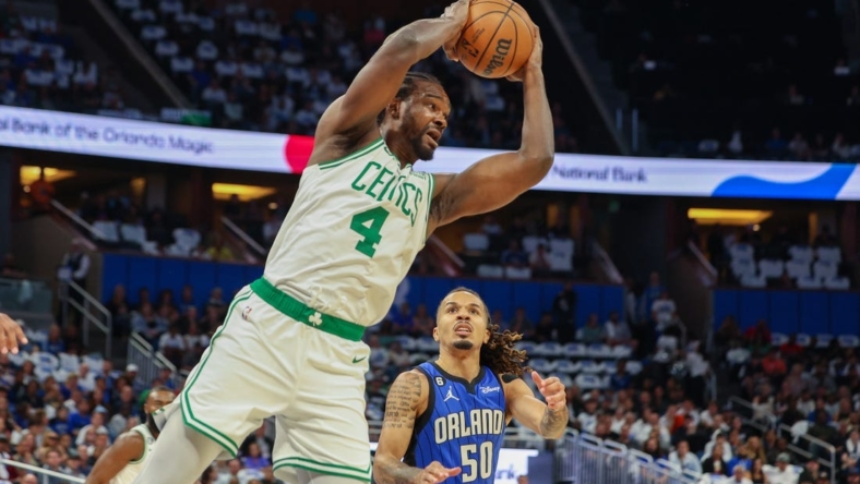 Oct 22, 2022; Orlando, Florida, USA;  Boston Celtics forward Noah Vonleh (4) rebounds the ball against the Orlando Magic in the first quarter at Amway Center. Mandatory Credit: Nathan Ray Seebeck-USA TODAY Sports
