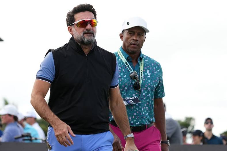 Oct 29, 2022; Miami, Florida, USA; Yasir Al-Rumayyan (L) walks next to Saudi golf CEO Majed Al Surour (R) during the second round of the season finale of the LIV Golf series at Trump National Doral. Mandatory Credit: Jasen Vinlove-USA TODAY Sports