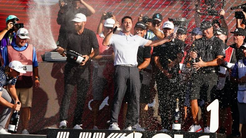 Oct 30, 2022; Miami, Florida, USA; Dustin Johnson , Patrick Reed , Talor Gooch and Pat Perez celebrates team 4Aces GC winning the season finale of the LIV Golf series at Trump National Doral. Mandatory Credit: John David Mercer-USA TODAY Sports