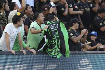 Oct 30, 2022; Los Angeles, California, USA; An Austin FC fan cheers during the conference finals for the Audi 2022 MLS Cup Playoffs against the Los Angeles FC at Banc of California Stadium. Mandatory Credit: Kiyoshi Mio-USA TODAY Sports