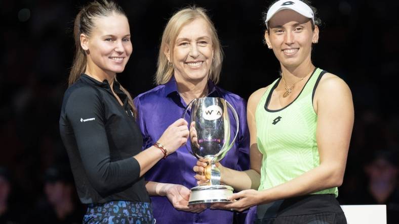 Nov 7, 2022; Forth Worth, TX, USA; Martina Navratilova, Elise Mertens (BEL) and Veronika Kudermetova pose with the trophy after winning the doubles final against Barbora Krejcikova (CZE) and Katerina Siniakova (CZE) on day eight of the WTA Finals at Dickies Arena.