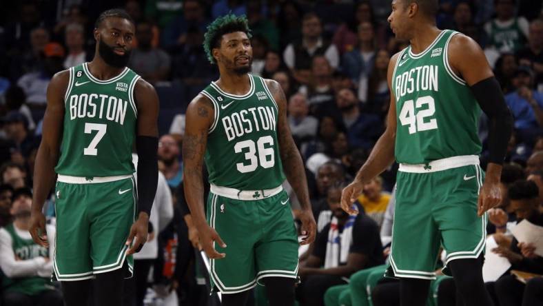 Nov 7, 2022; Memphis, Tennessee, USA; Boston Celtics guard Jaylen Brown (7) guard Marcus Smart (36) and  center Al Horford (42) talk during a timeout during the first half against the Memphis Grizzlies at FedExForum. Mandatory Credit: Petre Thomas-USA TODAY Sports