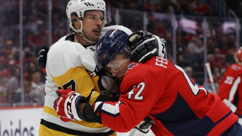 Nov 9, 2022; Washington, District of Columbia, USA; Pittsburgh Penguins center Sidney Crosby (87) scrums with Washington Capitals defenseman Martin Fehervary (42) in the second period at Capital One Arena. Mandatory Credit: Geoff Burke-USA TODAY Sports