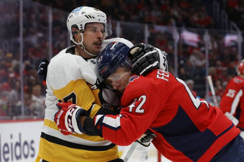 Nov 9, 2022; Washington, District of Columbia, USA; Pittsburgh Penguins center Sidney Crosby (87) scrums with Washington Capitals defenseman Martin Fehervary (42) in the second period at Capital One Arena. Mandatory Credit: Geoff Burke-USA TODAY Sports