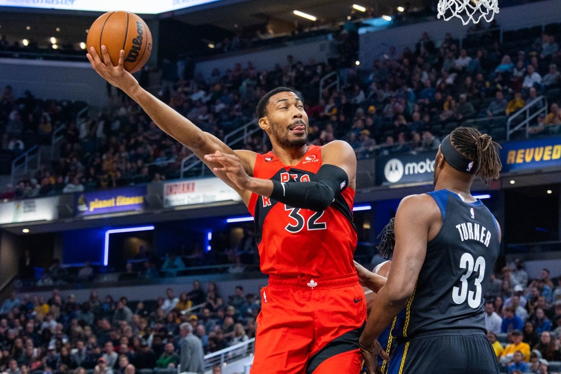 Nov 12, 2022; Indianapolis, Indiana, USA; Toronto Raptors forward Otto Porter Jr. (32) shoots the ball while Indiana Pacers center Myles Turner (33) defends in the first quarter at Gainbridge Fieldhouse. Mandatory Credit: Trevor Ruszkowski-USA TODAY Sports