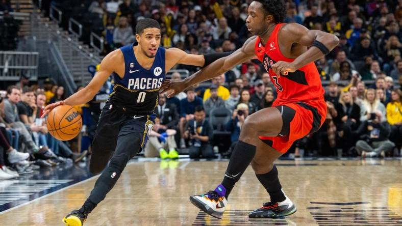 Nov 12, 2022; Indianapolis, Indiana, USA; Indiana Pacers guard Tyrese Haliburton (0) dribbles the ball while Toronto Raptors forward O.G. Anunoby (3) defends in the second  half at Gainbridge Fieldhouse. Mandatory Credit: Trevor Ruszkowski-USA TODAY Sports