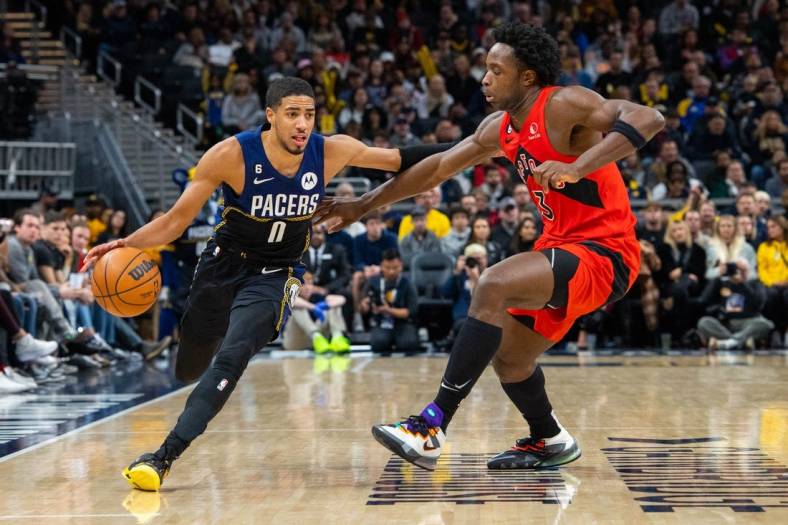 Nov 12, 2022; Indianapolis, Indiana, USA; Indiana Pacers guard Tyrese Haliburton (0) dribbles the ball while Toronto Raptors forward O.G. Anunoby (3) defends in the second  half at Gainbridge Fieldhouse. Mandatory Credit: Trevor Ruszkowski-USA TODAY Sports
