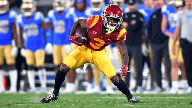 Nov 19, 2022; Pasadena, California, USA; Southern California Trojans wide receiver Jordan Addison (3) runs the ball against the UCLA Bruins during the first half at the Rose Bowl. Mandatory Credit: Gary A. Vasquez-USA TODAY Sports