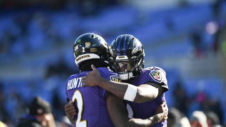 Nov 20, 2022; Baltimore, Maryland, USA;  Baltimore Ravens quarterback Tyler Huntley (2) and quarterback Lamar Jackson (8) hug before the start of the game against the Carolina Panthers at M&T Bank Stadium. Mandatory Credit: Tommy Gilligan-USA TODAY Sports