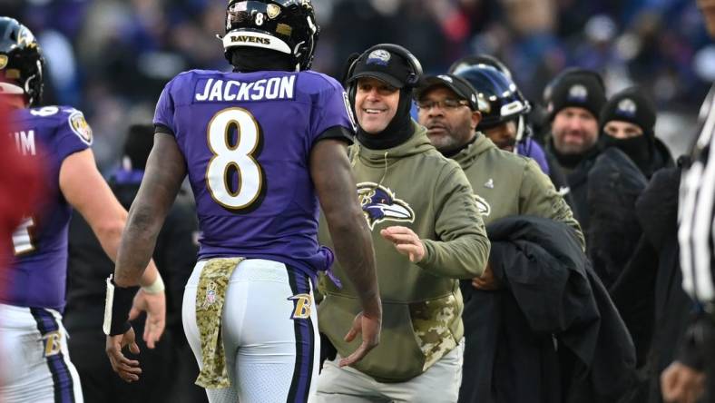 Nov 20, 2022; Baltimore, Maryland, USA;  Baltimore Ravens head coach John Harbaugh greets quarterback Lamar Jackson (8) after scoring a second half touchdown against the Carolina Panthers  at M&T Bank Stadium. Mandatory Credit: Tommy Gilligan-USA TODAY Sports