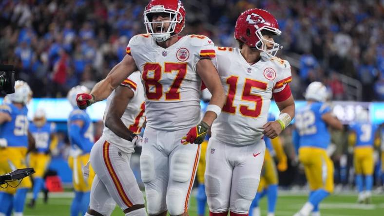 Nov 20, 2022; Inglewood, California, USA; Kansas City Chiefs tight end Travis Kelce (87) celebrates with quarterback Patrick Mahomes (15) after scoring on a 17-yard touchdown reception with 31 seconds left against the Los Angeles Chargers SoFi Stadium. Mandatory Credit: Kirby Lee-USA TODAY Sports