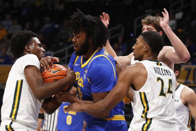 Nov 25, 2022; Pittsburgh, Pennsylvania, USA; William & Mary Tribe guard Gabe Dorsey (left) and Pittsburgh Panthers forward John Hugley IV (4) battle for the ball during the first half at Petersen Events Center. Mandatory Credit: Charles LeClaire-USA TODAY Sports