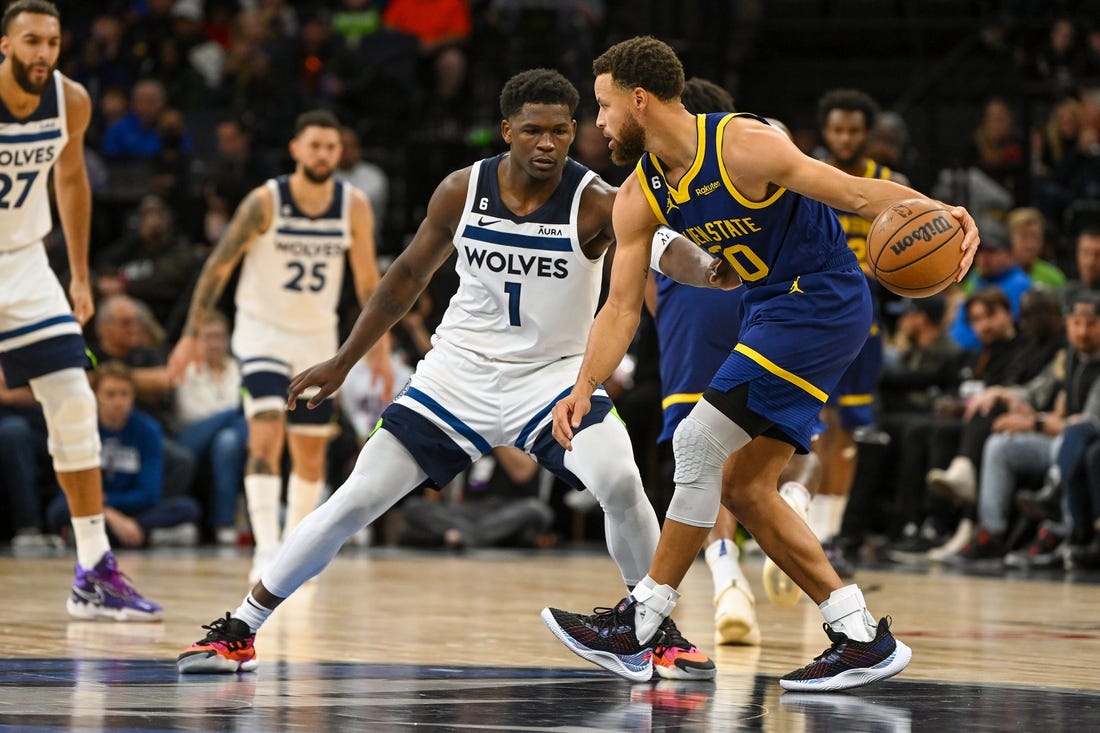 Nov 27, 2022; Minneapolis, Minnesota, USA; Golden State Warriors guard Stephen Curry (30) protects the ball from Minnesota Timberwolves forward Anthony Edwards (1) during the second half at Target Center. Mandatory Credit: Nick Wosika-USA TODAY Sports