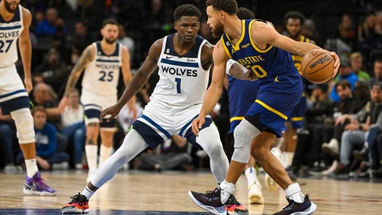 Nov 27, 2022; Minneapolis, Minnesota, USA; Golden State Warriors guard Stephen Curry (30) protects the ball from Minnesota Timberwolves forward Anthony Edwards (1) during the second half at Target Center. Mandatory Credit: Nick Wosika-USA TODAY Sports