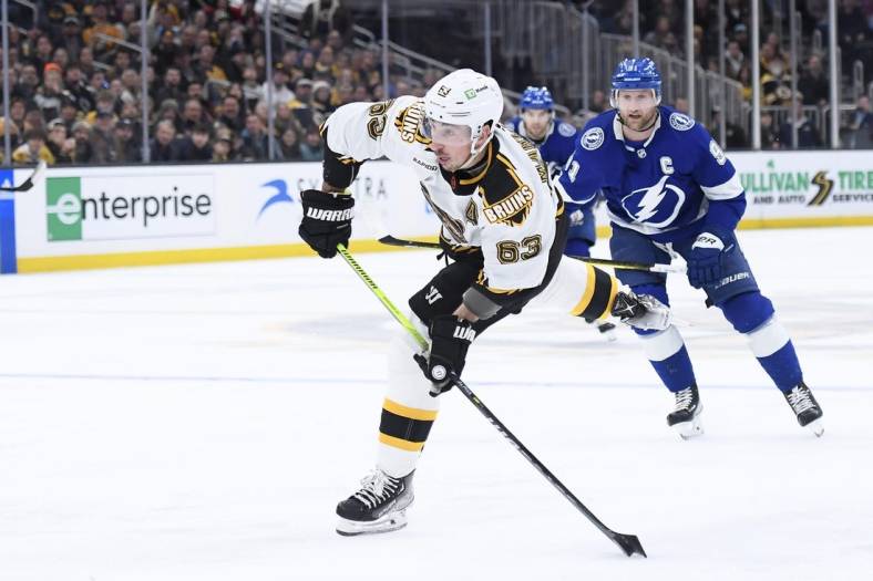 Nov 29, 2022; Boston, Massachusetts, USA;  Boston Bruins left wing Brad Marchand (63) shoots the puck on goal during the third period against the Tampa Bay Lightning at TD Garden. Mandatory Credit: Bob DeChiara-USA TODAY Sports