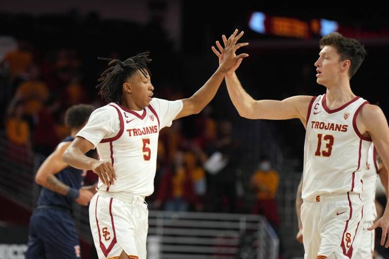 Dec 7, 2022; Los Angeles, California, USA; Southern California Trojans guard Boogie Ellis (5) and guard Drew Peterson (13) celebrate against the Cal State Fullerton Titans in the first half at Galen Center. Mandatory Credit: Kirby Lee-USA TODAY Sports