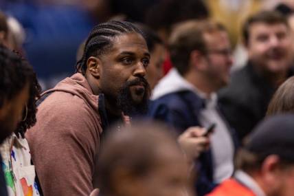 Dec 9, 2022; New Orleans, Louisiana, USA; New Orleans Saints defensive end Cam Jordan looks on at the game between the New Orleans Pelicans and the Phoenix Suns during the first half at Smoothie King Center. Mandatory Credit: Stephen Lew-USA TODAY Sports
