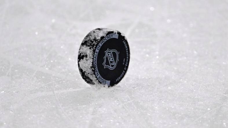 Dec 10, 2022; Montreal, Quebec, CAN; A NHL puck with the French logo during the warmup period before the game between the Los Angeles Kings and the Montreal Canadiens at the Bell Centre. Mandatory Credit: Eric Bolte-USA TODAY Sports