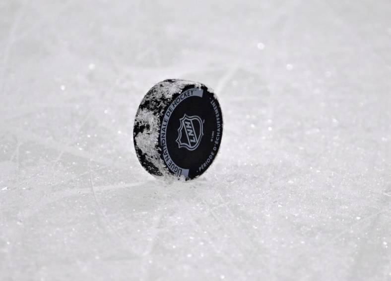 Dec 10, 2022; Montreal, Quebec, CAN; A NHL puck with the French logo during the warmup period before the game between the Los Angeles Kings and the Montreal Canadiens at the Bell Centre. Mandatory Credit: Eric Bolte-USA TODAY Sports