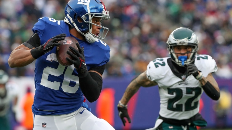Dec 11, 2022; East Rutherford, New Jersey, USA; New York Giants running back Saquon Barkley (26) catches the ball against Philadelphia Eagles safety Marcus Epps (22) during the second quarter at MetLife Stadium. Mandatory Credit: Tom Horak-USA TODAY Sports
