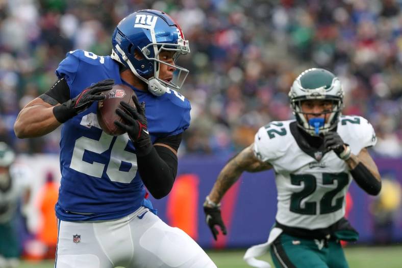 Dec 11, 2022; East Rutherford, New Jersey, USA; New York Giants running back Saquon Barkley (26) catches the ball against Philadelphia Eagles safety Marcus Epps (22) during the second quarter at MetLife Stadium. Mandatory Credit: Tom Horak-USA TODAY Sports