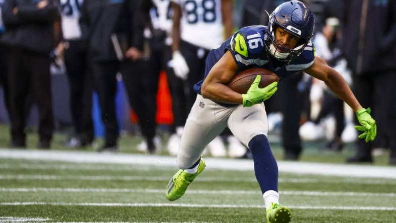 Dec 11, 2022; Seattle, Washington, USA; Seattle Seahawks wide receiver Tyler Lockett (16) runs for yards after the catch against the Carolina Panthers during the second quarter at Lumen Field. Mandatory Credit: Joe Nicholson-USA TODAY Sports