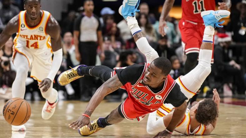 Dec 11, 2022; Atlanta, Georgia, USA; Chicago Bulls forward Javonte Green (24) and Atlanta Hawks guard Trae Young (11) fight for the ball on the floor during the second half at State Farm Arena. Mandatory Credit: Dale Zanine-USA TODAY Sports