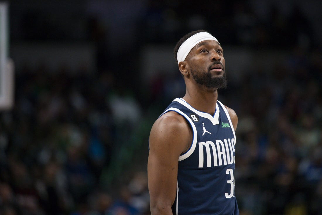 Dec 16, 2022; Dallas, Texas, USA; Dallas Mavericks guard Kemba Walker (34) checks the scoreboard as he enters the game against the Portland Trail Blazers during the second quarter at the American Airlines Center. Mandatory Credit: Jerome Miron-USA TODAY Sports