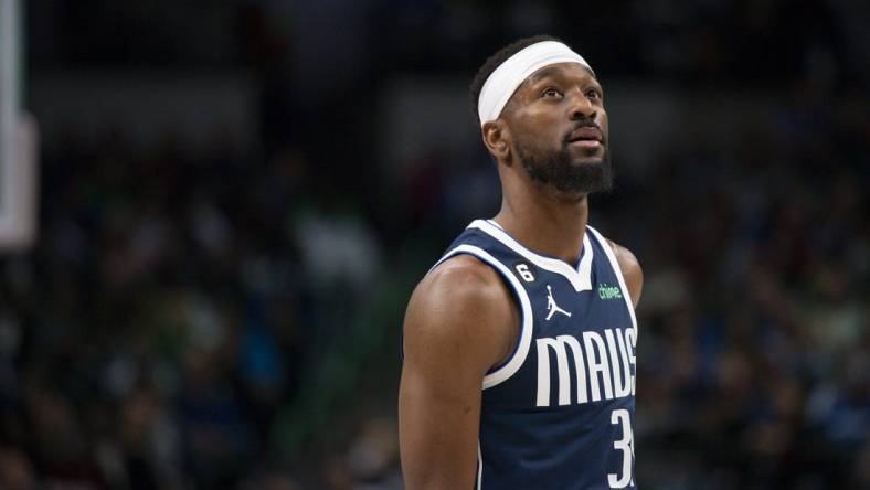 Dec 16, 2022; Dallas, Texas, USA; Dallas Mavericks guard Kemba Walker (34) checks the scoreboard as he enters the game against the Portland Trail Blazers during the second quarter at the American Airlines Center. Mandatory Credit: Jerome Miron-USA TODAY Sports