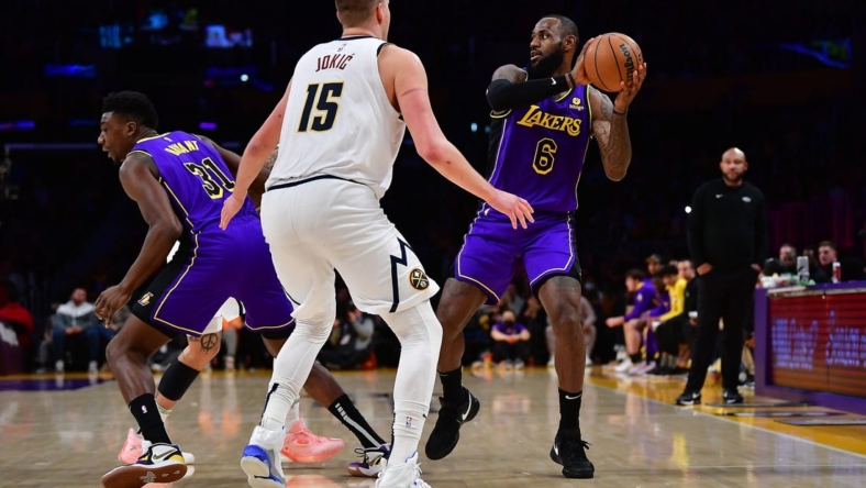Dec 16, 2022; Los Angeles, California, USA; Los Angeles Lakers forward LeBron James (6) controls the ball against Denver Nuggets center Nikola Jokic (15) during the second half at Crypto.com Arena. Mandatory Credit: Gary A. Vasquez-USA TODAY Sports