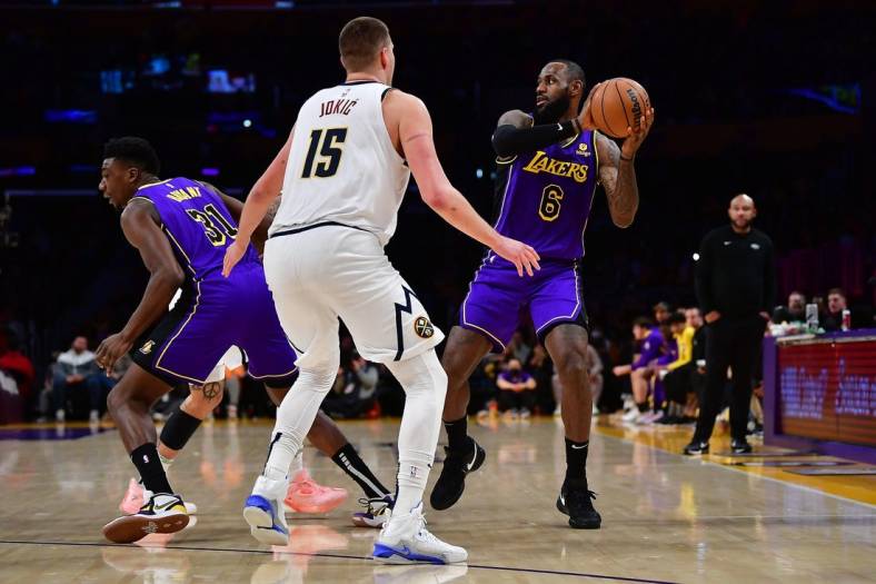 Dec 16, 2022; Los Angeles, California, USA; Los Angeles Lakers forward LeBron James (6) controls the ball against Denver Nuggets center Nikola Jokic (15) during the second half at Crypto.com Arena. Mandatory Credit: Gary A. Vasquez-USA TODAY Sports