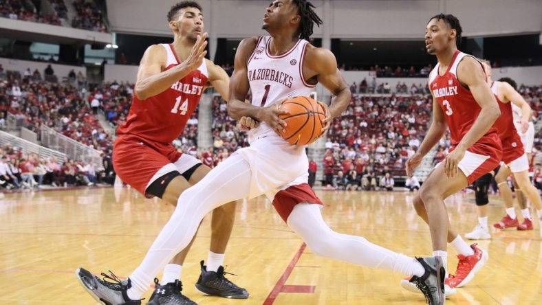 Dec 17, 2022; North Little Rock, Arkansas, USA; Arkansas Razorbacks guard Ricky Council IV (1) drives to the basket as Bradley Braves forward Malevy Leons (14) and guard Zek Montgomery (3) defend in the second half at Simmons Bank Arena. Arkansas won 76-57. Mandatory Credit: Nelson Chenault-USA TODAY Sports
